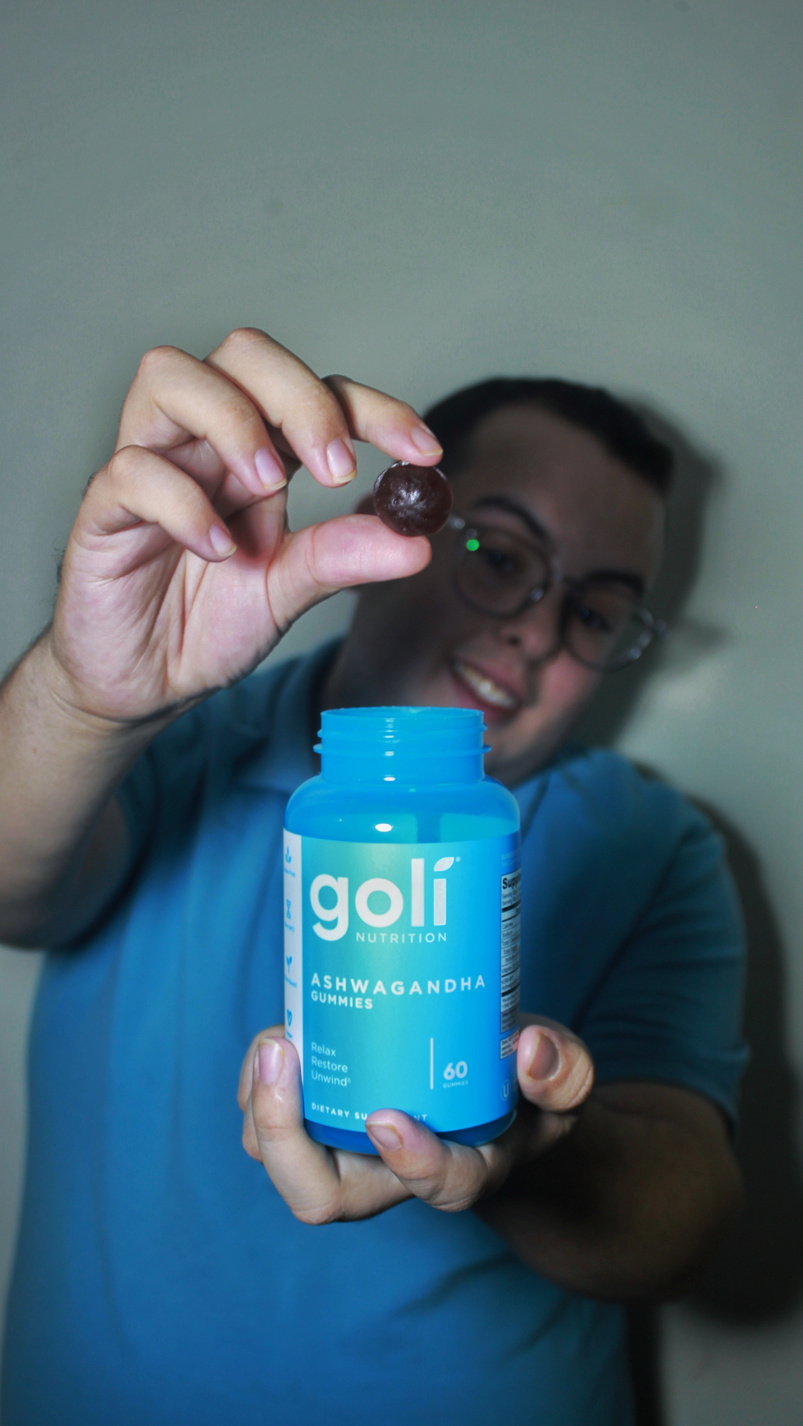 a UGC Creator holding up a bottle of Goli Ashwa Gummies